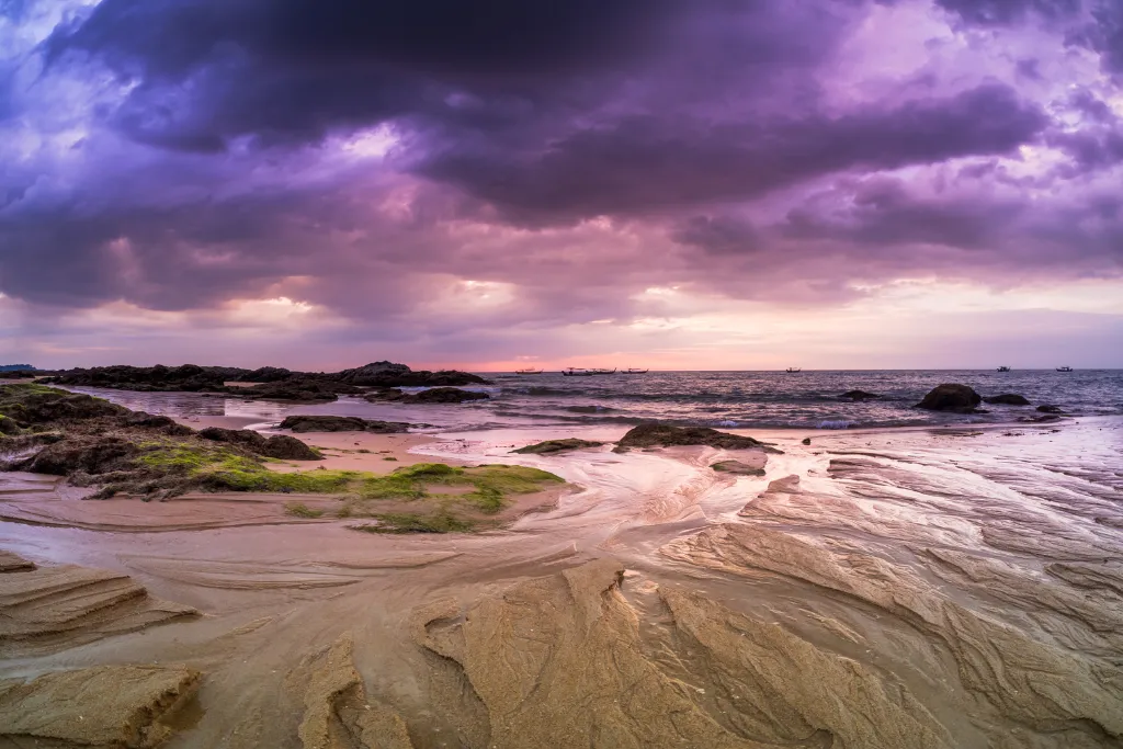 An artistic view of a beach at dusk, showcasing the raw and natural beauty of Khao Lak, an unforgettable destination for luxury travel clients.