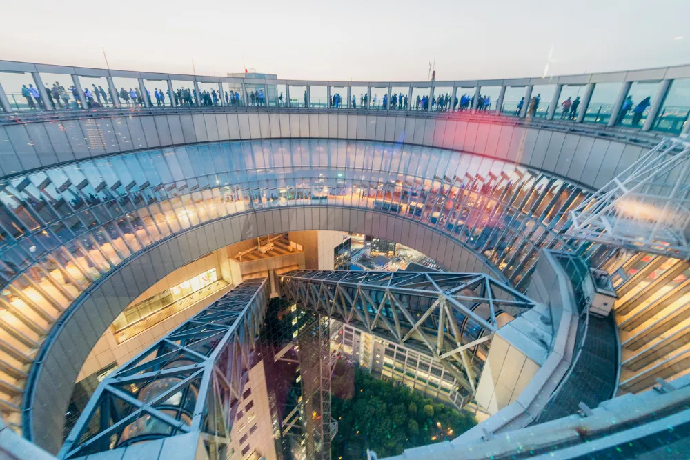 The futuristic Floating Garden Observatory at the Umeda Sky Building in Osaka offers a stunning panoramic view. This architectural marvel is a perfect experience for urban exploration and a memorable activity for MICE and luxury travel groups.
