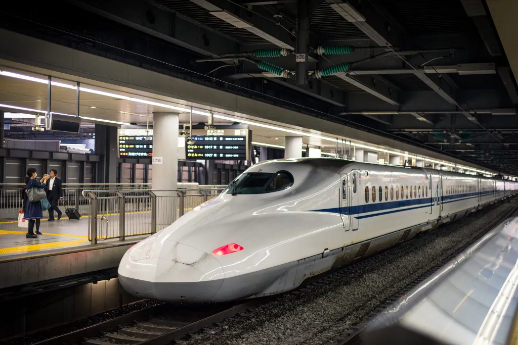 A sleek Shinkansen (bullet train) at a station in Tokyo, Japan, symbolizing the speed and luxury of ground transportation