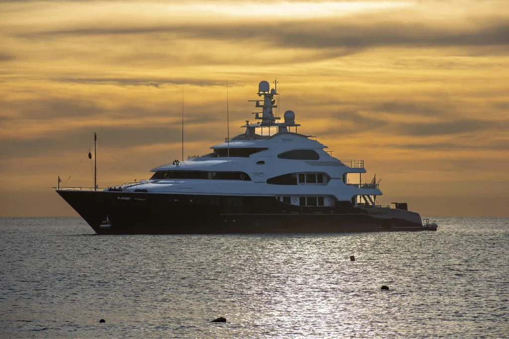Magnificent luxury superyacht anchored at sunset, ideal for exclusive Langkawi, Malaysia tours and private travel experiences. Book bespoke Malaysia holidays with our luxury DMC service.