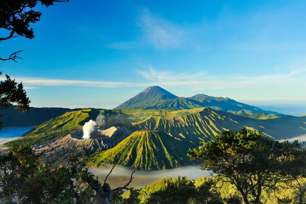 Panoramic vista of the Bromo-Tengger-Semeru National Park, featuring the active Mount Bromo volcano. Experience breathtaking Indonesia travel and bespoke luxury travel journeys through the natural wonders of East Java.