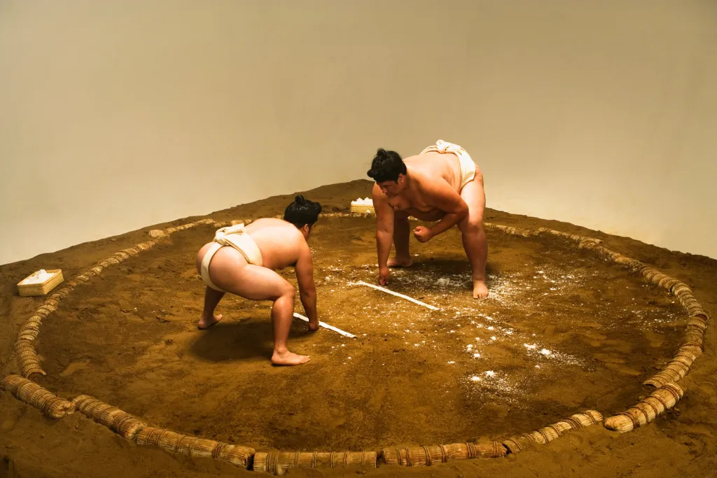 Two Sumo wrestlers preparing to engage in the Dohyō ring. Experience authentic cultural access on exclusive luxury Japan tours and custom Japan holidays designed by a Japan dmc.