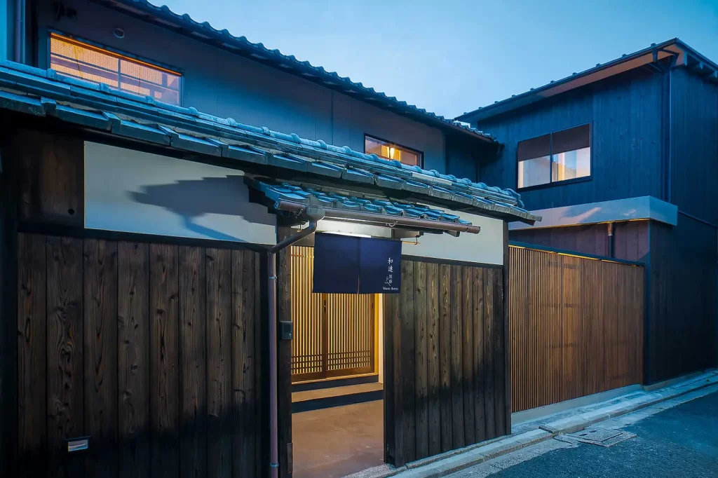 The beautifully lit, traditional entrance of a private luxury Kyoto Machiya villa. Experience authentic accommodation on bespoke Japan holidays and Japan travel itineraries arranged by a specialized Japan dmc.