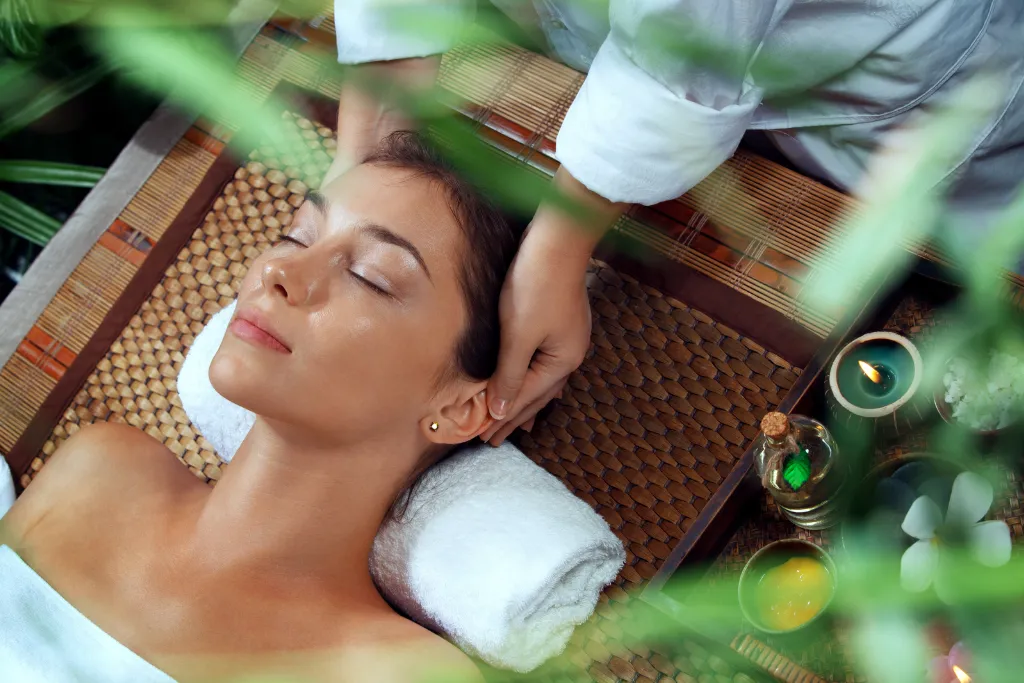 A woman enjoys a relaxing head and neck massage at a luxury spa. Enhance your Vietnam holidays with premium spa treatments and dedicated wellness travel packages at top Vietnam luxury hotels and resorts.