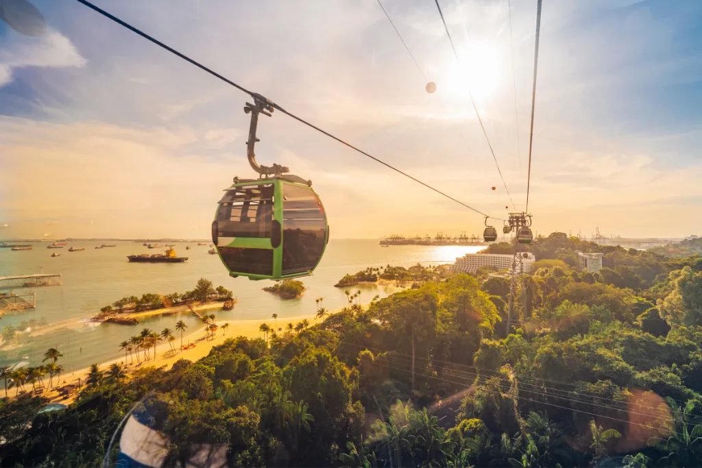 Riding the Sentosa Cable Car over the tropical beach and water in Singapore.