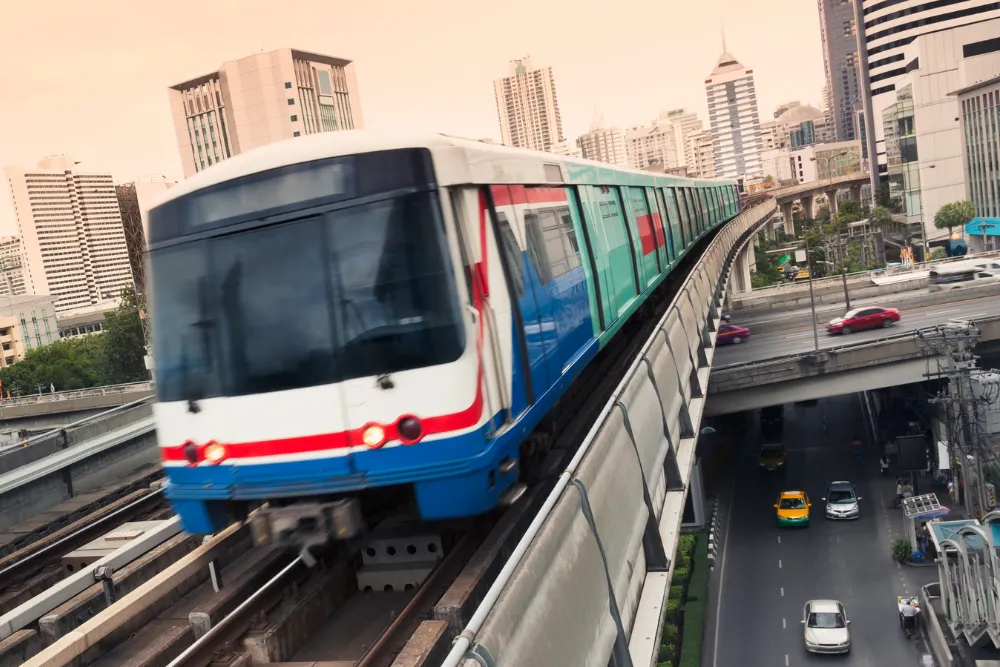 Bangkok's BTS Skytrain moving through the city's skyline at dusk