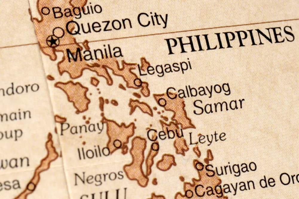 Vintage vintage-style map of the Philippines showing major cities like Manila and Cebu for Discovery DMC travel packages.