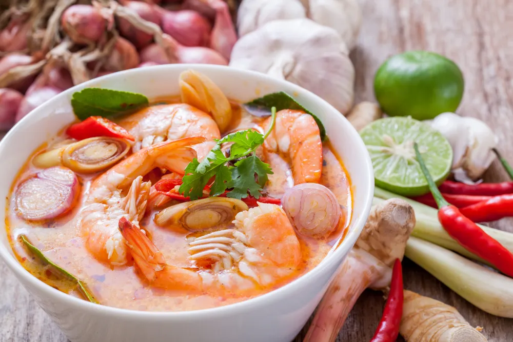 Tom yum goong, spicy Thai prawn soup with fresh galangal, lemongrass, and lime, served in Thailand