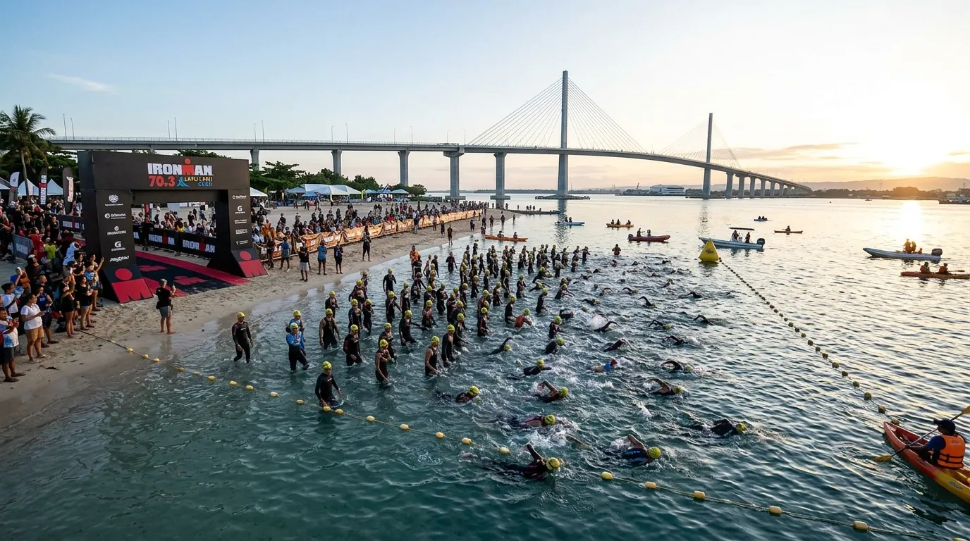 Triathletes entering the ocean at sunrise for the swim leg of IRONMAN 70.3 Lapu-Lapu in Cebu