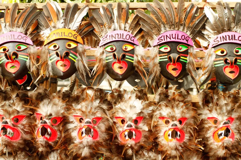 Traditional feather-adorned Sinulog Festival masks from Cebu, highlighted in cultural Philippines DMC travel itineraries.