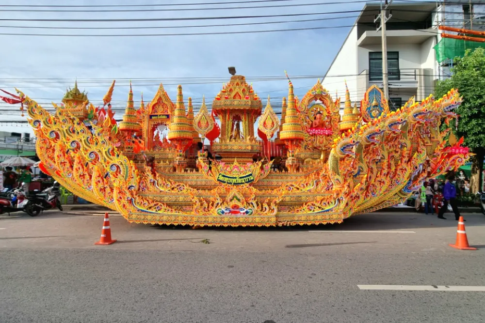 Intricately carved golden and orange Thai temple parade float
