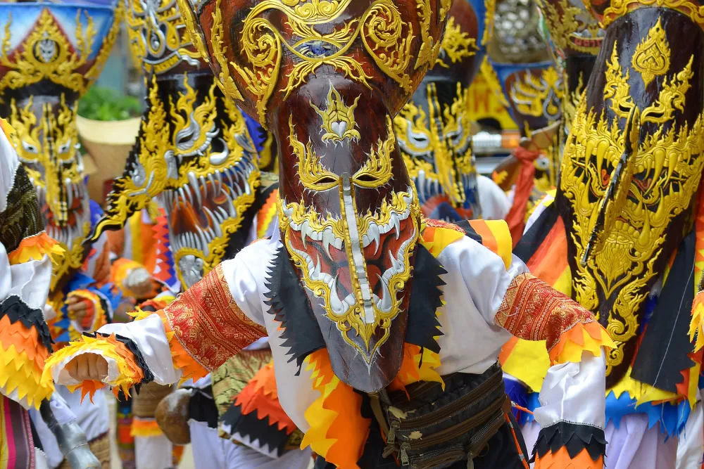 Performer wearing a colorful traditional ghost mask at the Phi Ta Khon festival arranged by a local Thailand DMC.